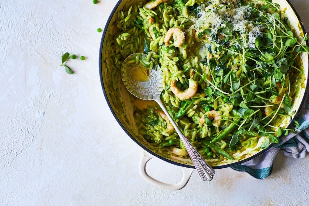 A bowl of green seafood risotto made using Yeo Valley products